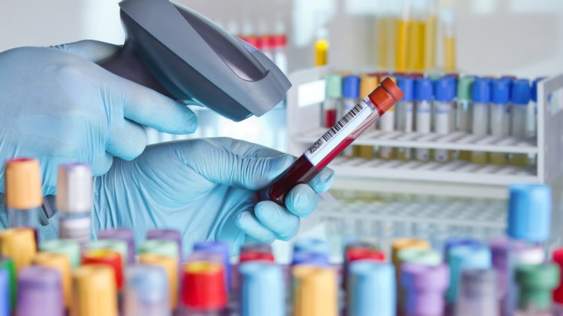 Health Technician Scanning Blood In Tube